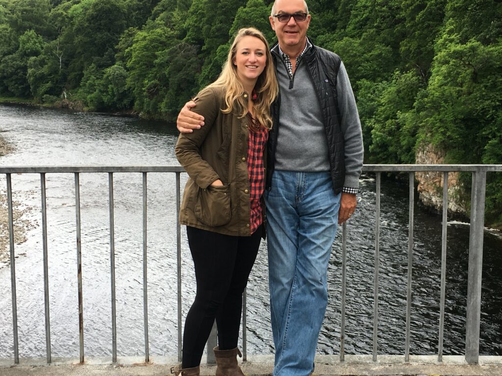 James and younger daughter at a scenic overlook in front of a river